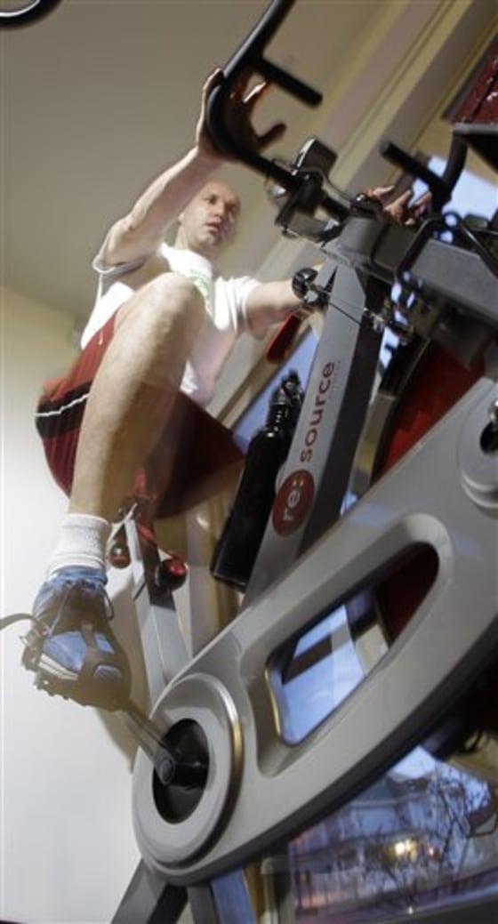 A March 30, 2011, photo shows Adam Boesel working out on a stationary bike hooked up to a generator at the Green Microgym Wednesday, March 30, 2011, in Portland, Ore. The equipment satisfies a demand among the 200 members to be fit in a way that fits Portland?s green-indie-local ethos. (AP Photo/Rick Bowmer)